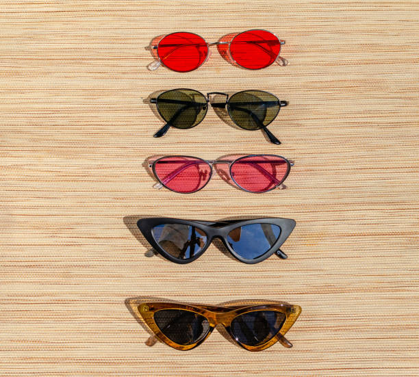 istock Different sunglasses on a straw backing in the sun. Summer scene, optics, eye protection 1160059381