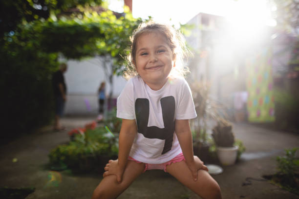 Girl (10 years, mixed race Hispanic/Caucasian) standing outdoors.