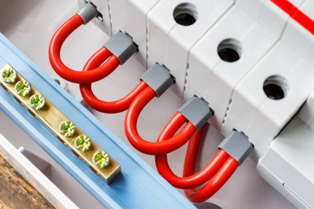 istock Ports of automatic circuit breakers connected by red wires closeup 1160064440