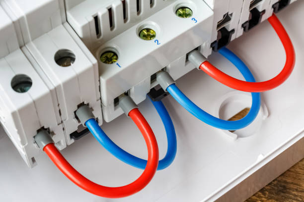 istock Ports of installed automatic circuit breakers connected by red and blue wires closeup 1160064451