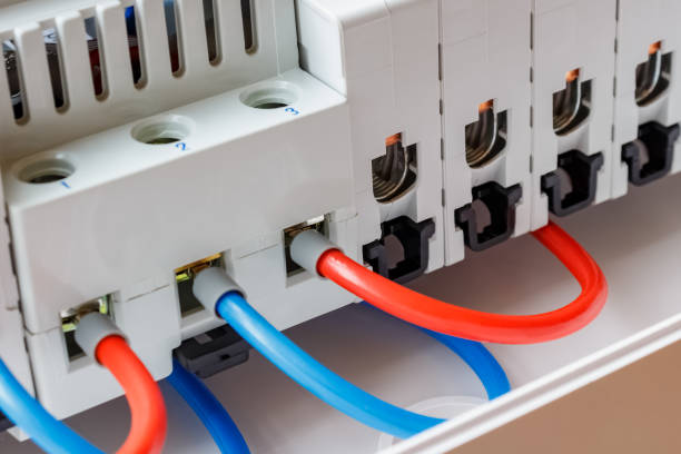 istock Ports of installed automatic circuit breakers connected by red and blue wires closeup 1160064454