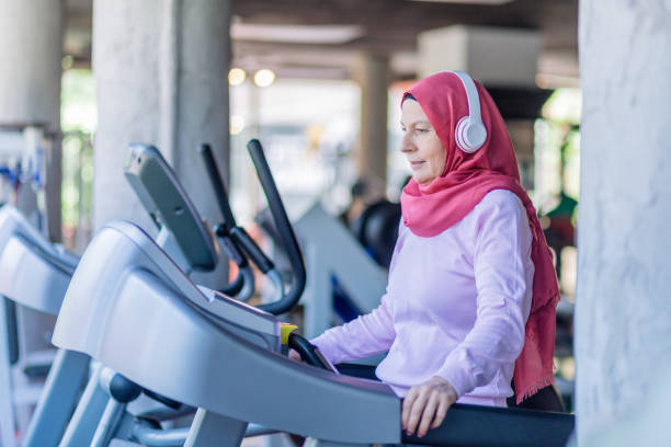 istock muslim woman running on treadmill 1160068841