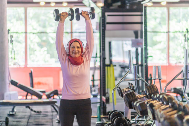 istock Muslim Woman Exercising for shoulders 1160070033