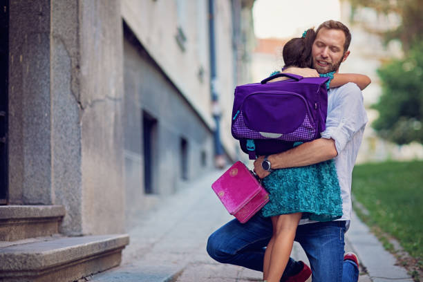 istock Father is sending his daughter to school 1160070103