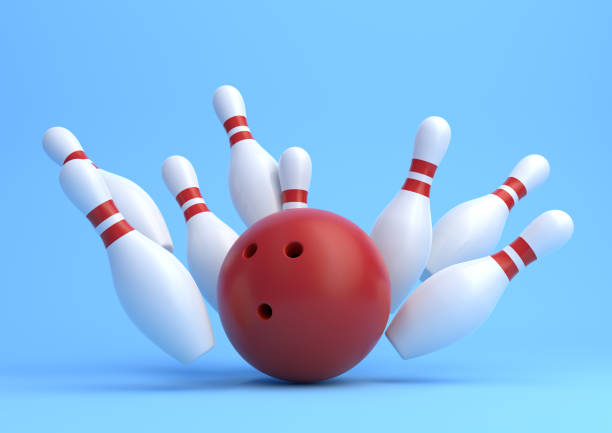 istock Red Bowling Ball and scattered white skittles isolated on blue background 1160070273