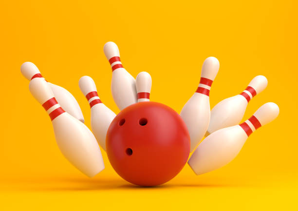 roter bowlingball und verstreute weiße kegel auf gelbem hintergrund - bowlingkugel stock-fotos und bilder