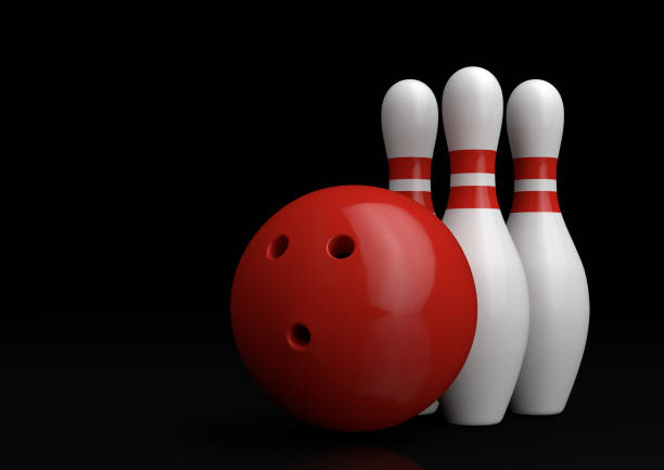 istock Red Bowling Ball and white skittles isolated on black background 1160070301