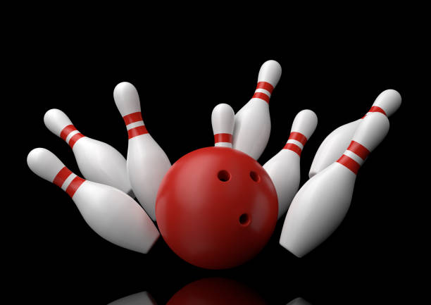 istock Red Bowling Ball and scattered white skittles isolated on black background 1160070307