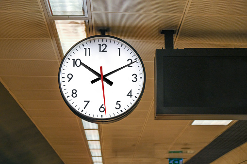 Big clock on metro station's ceiling, selective focus.