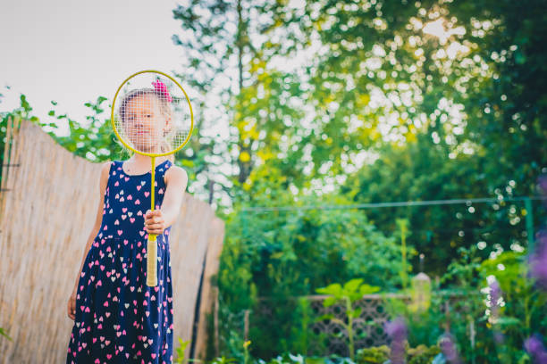 istock Girl playing badminton 1160078827