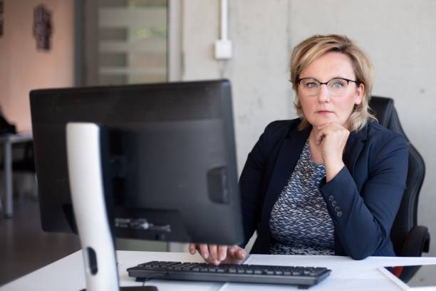 istock Middle aged woman working in office 1160080308