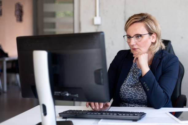 istock Middle aged woman working in office 1160080365