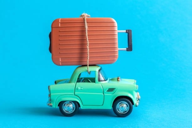 istock Car toy and luggage abstract isolated on blue. 1160087564