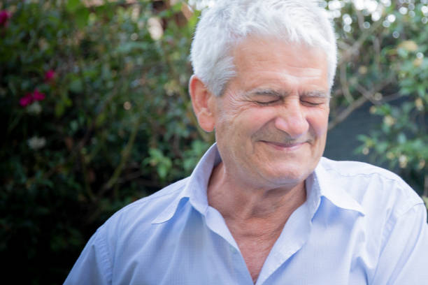 istock Mature man portrait with funny expression and closed eyes. 1160087827