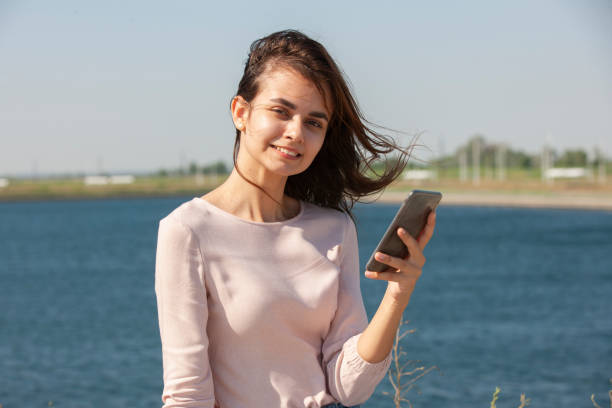 istock Beautiful girl sitting on a bench, brunette 1160088092