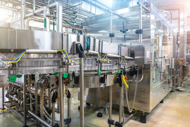 istock Automated industrial machine tool conveyor equipment for bottling juice into plastic bottles in beverage factory interior 1160088135