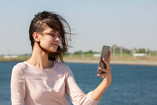 istock Beautiful girl sitting on a bench, brunette 1160089312