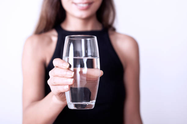istock sick woman drinking water and pill 1160090354
