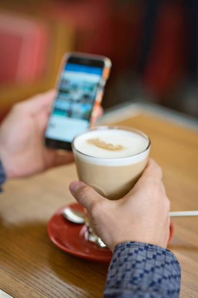 istock man with coffee and smartphone 1160091458