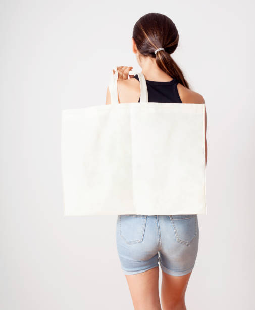 istock woman holding cotton fabric bag 1160091538
