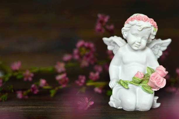 Angel holding bunch of roses