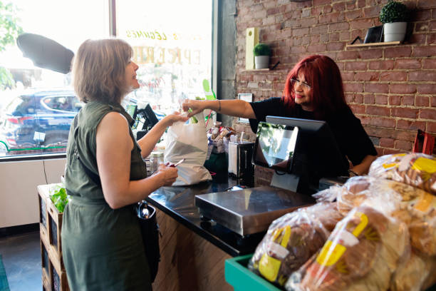 Customers shopping in small zero waste oriented fruit and grocery store.