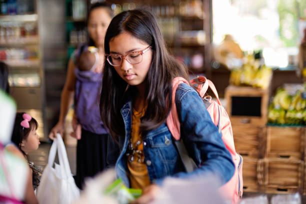 Customers shopping in small zero waste oriented fruit and grocery store.