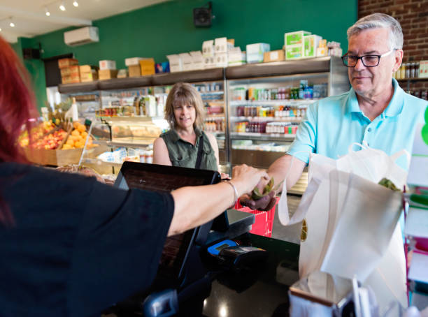 Customers shopping in small zero waste oriented fruit and grocery store.