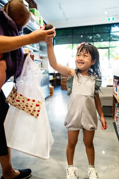 Customers shopping in small zero waste oriented fruit and grocery store.