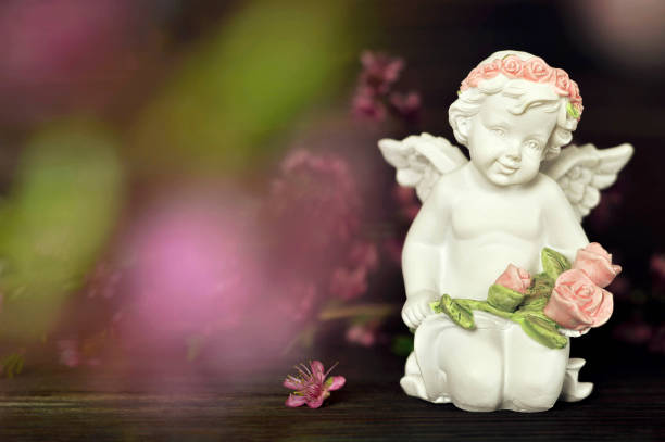 istock Cherub holding flowers 1160094345