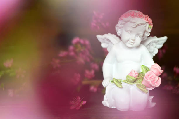 istock Guardian angel holding flowers 1160095935