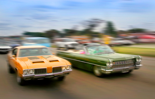 Orange and green color muscle cars cruising on historic woodward avenue.