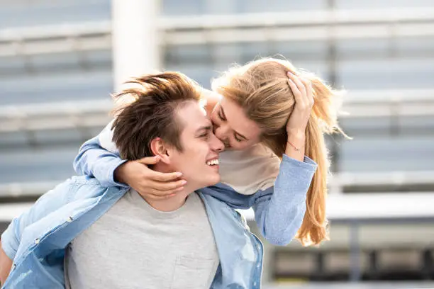 Photo of Attractive boy and girl hugging and kissing.