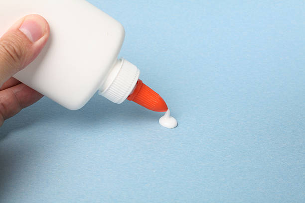 glue a bottle of glue, school supplies solvent stock pictures, royalty-free photos & images