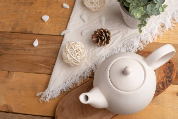 istock Ceramic white teapot with accessories on a wooden table, horizontal frame, tea time, tea drinking, retual tea making 1160100020