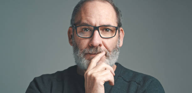 portrait of a bearded mature adult casual businessman with glasses looking into camera - old human face men ceo imagens e fotografias de stock