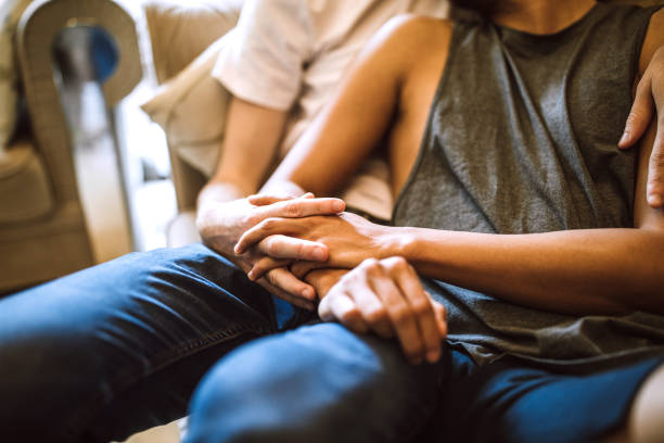 istock Romantic gay couple embracing on sofa 1160103099