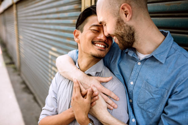 istock Two same-sex partners flirting on the street 1160103113