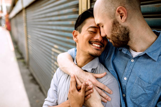 istock Two same-sex partners flirting on the street 1160103233