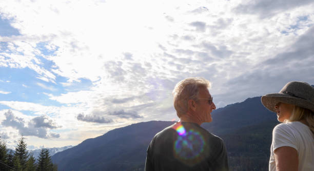 istock Mature couple hike in mountains on a sunny day 1160104944