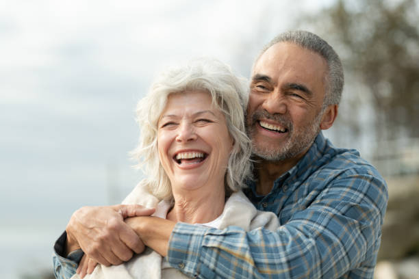 istock Laughing senior couple on a beach 1160108756