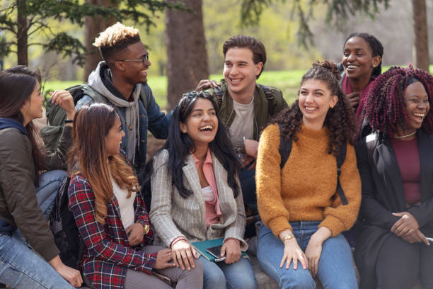 istock Multi-Ethnic Group of University Students Sitting Outside Together 1160108866