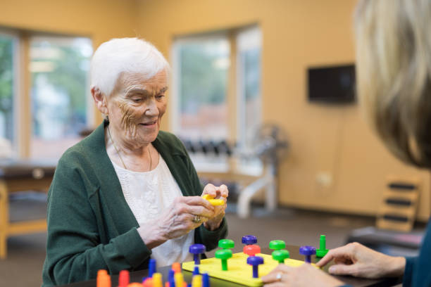 istock Occupational therapist works with an elderly woman 1160109174