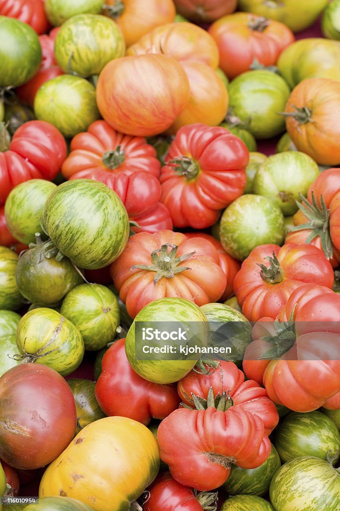 Heirloom Tomatoes Several varieties of heirloom tomatoes at an outdoor farmer's market. Heirloom Tomato Stock Photo