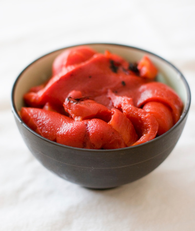 Strips of roasted red bell peppers in a small bowl.