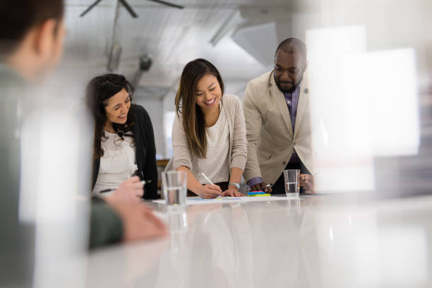 istock Businesspeople signing contracts at a conference table 1160111880