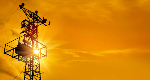 istock electricity power line tower over orange color sunset sky 1160115014