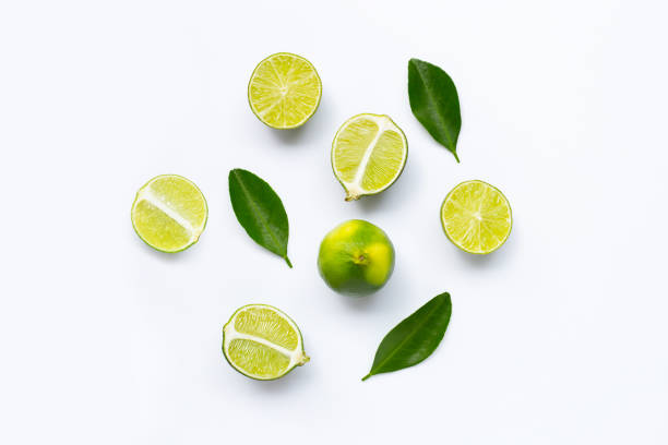 istock Fresh limes with leaves isolated on white 1160124919
