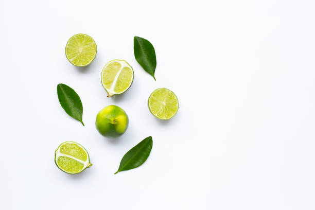 istock Fresh limes with leaves isolated on white 1160125864
