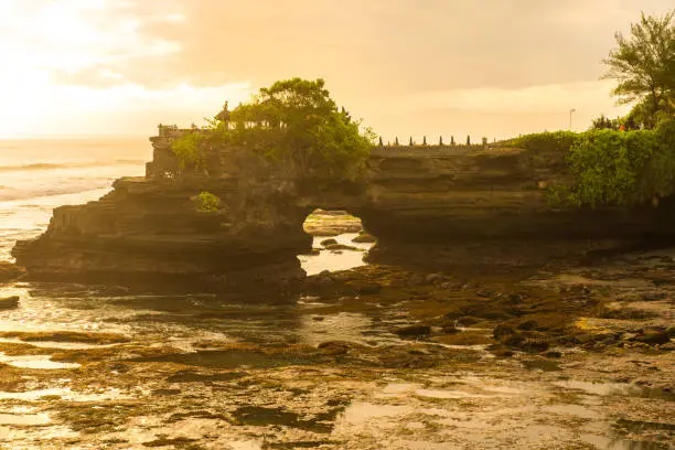 Photo of Pura Batu Bolong an iconic Hinduism sea temple nearly Tanah Lot temple in Bali island of Indonesia at evening.